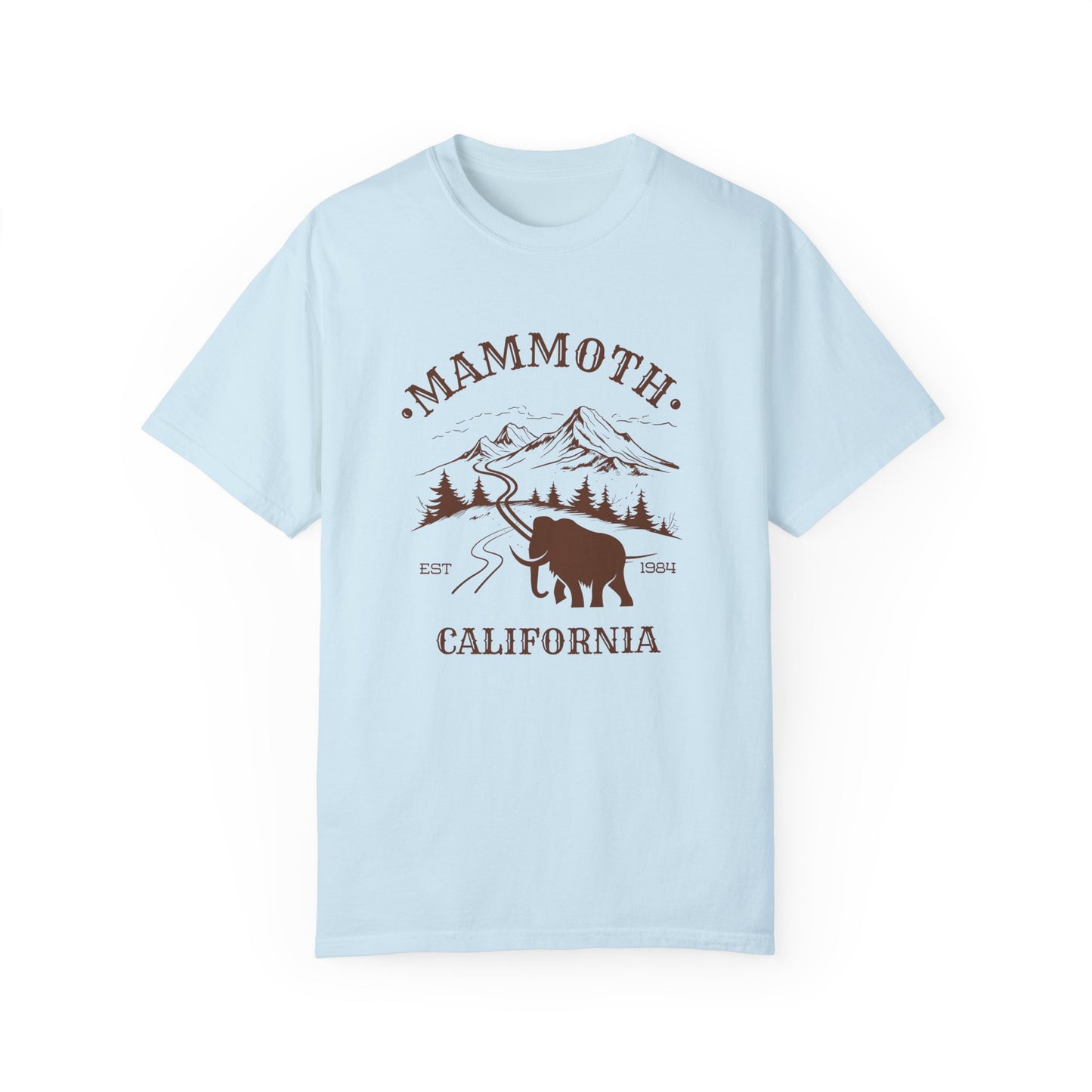 A light blue t-shirt featuring a mammoth silhouette with a ski mountain backdrop and the text 'MAMMOTH CALIFORNIA'.