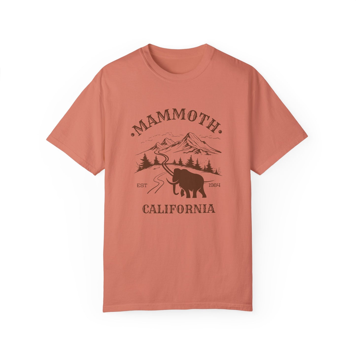 An orange t-shirt featuring a mammoth silhouette with a ski mountain backdrop and the text 'MAMMOTH CALIFORNIA'.