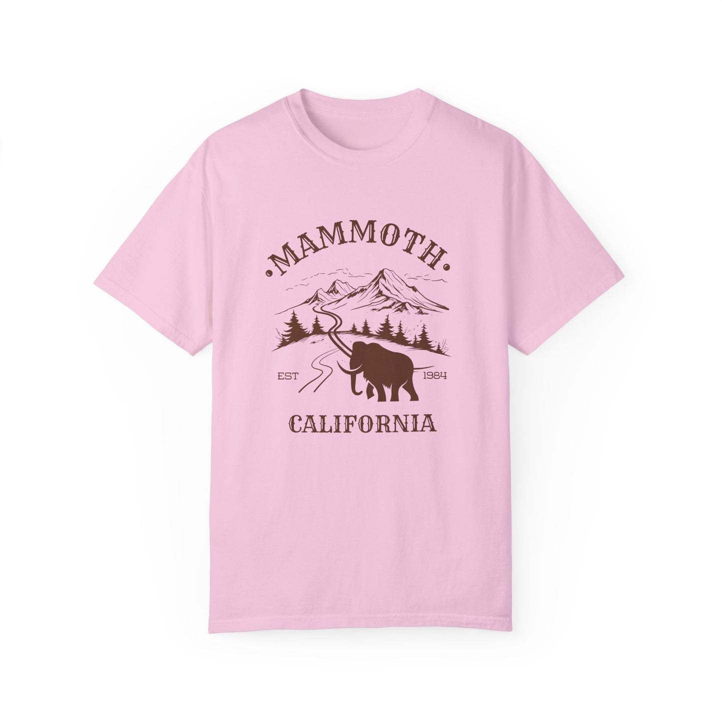 A pink t-shirt featuring a mammoth silhouette with a ski mountain backdrop and the text 'MAMMOTH CALIFORNIA'.
