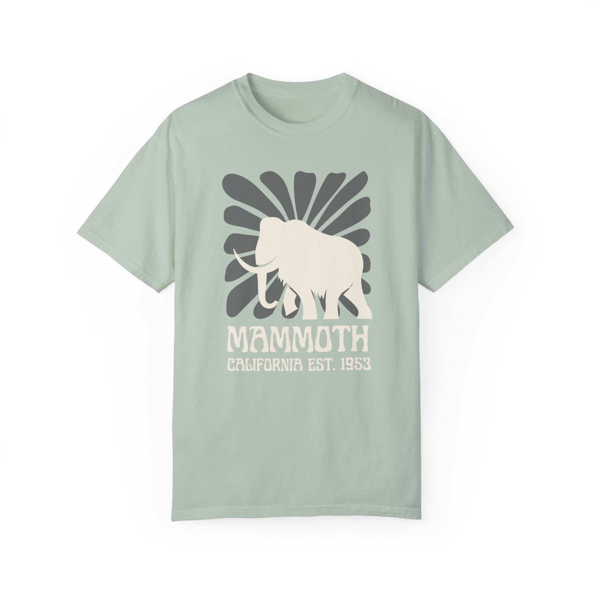 A light green t-shirt featuring a silhouette of a mammoth with the text 'MAMMOTH CALIFORNIA EST. 1953' on the front.