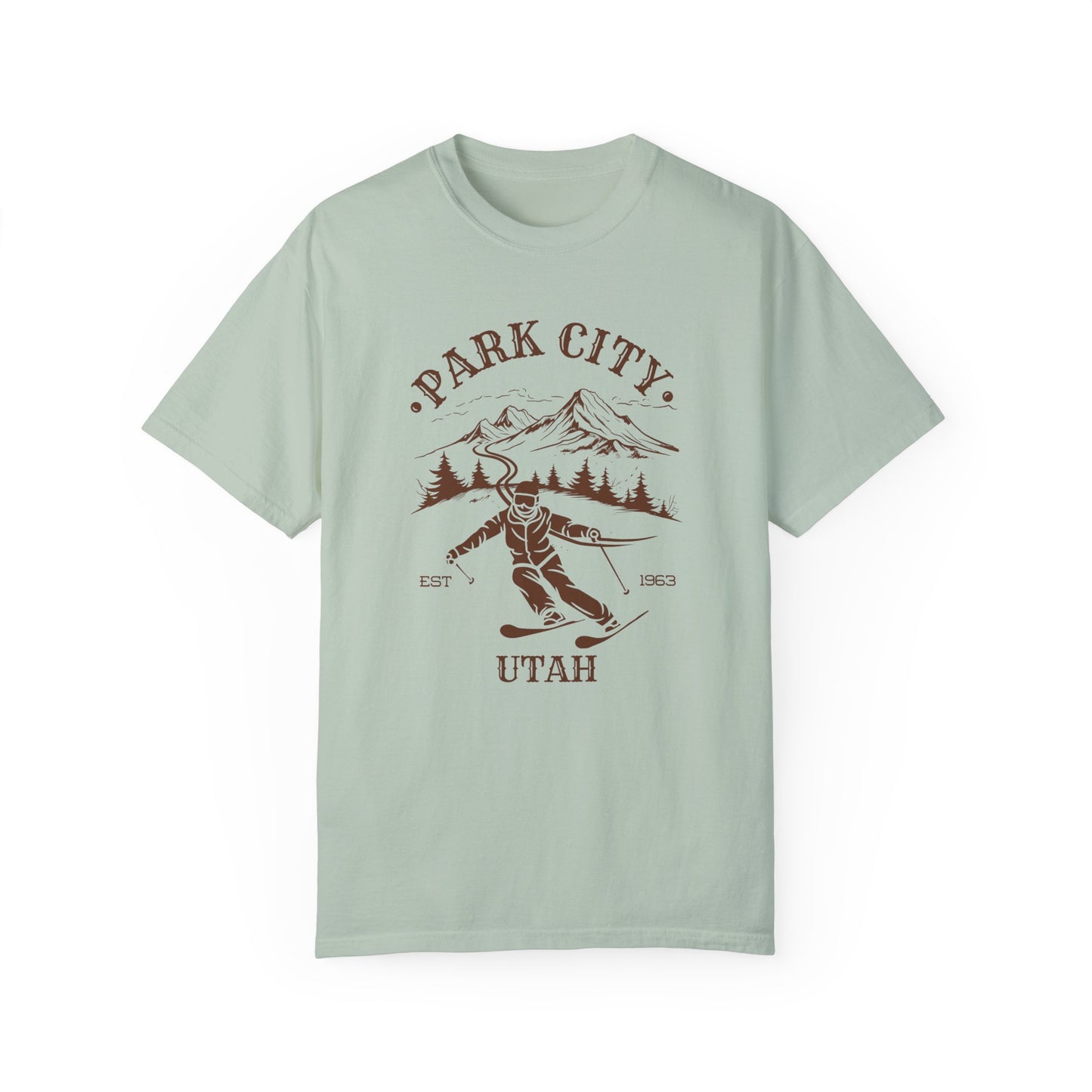 A green t-shirt featuring a skier silhouette with a ski mountain backdrop and the text 'PARK CITY UTAH'.