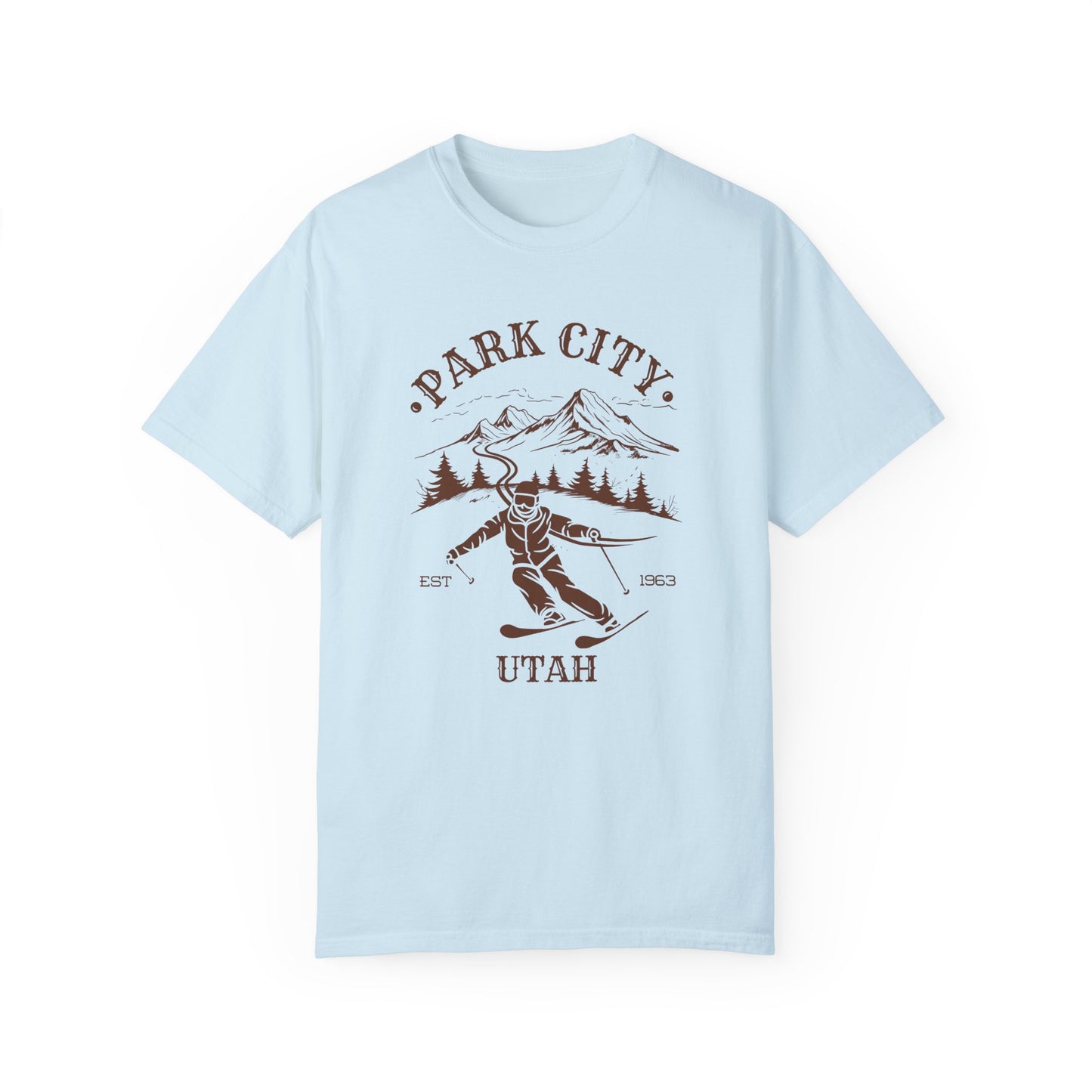 A light blue t-shirt featuring a skier silhouette with a ski mountain backdrop and the text 'PARK CITY UTAH'.