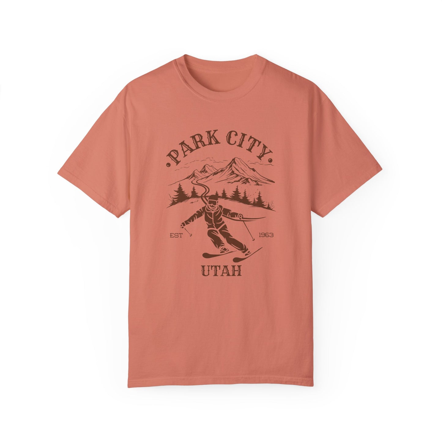 An orange t-shirt featuring a skier silhouette with a ski mountain backdrop and the text 'PARK CITY UTAH'.