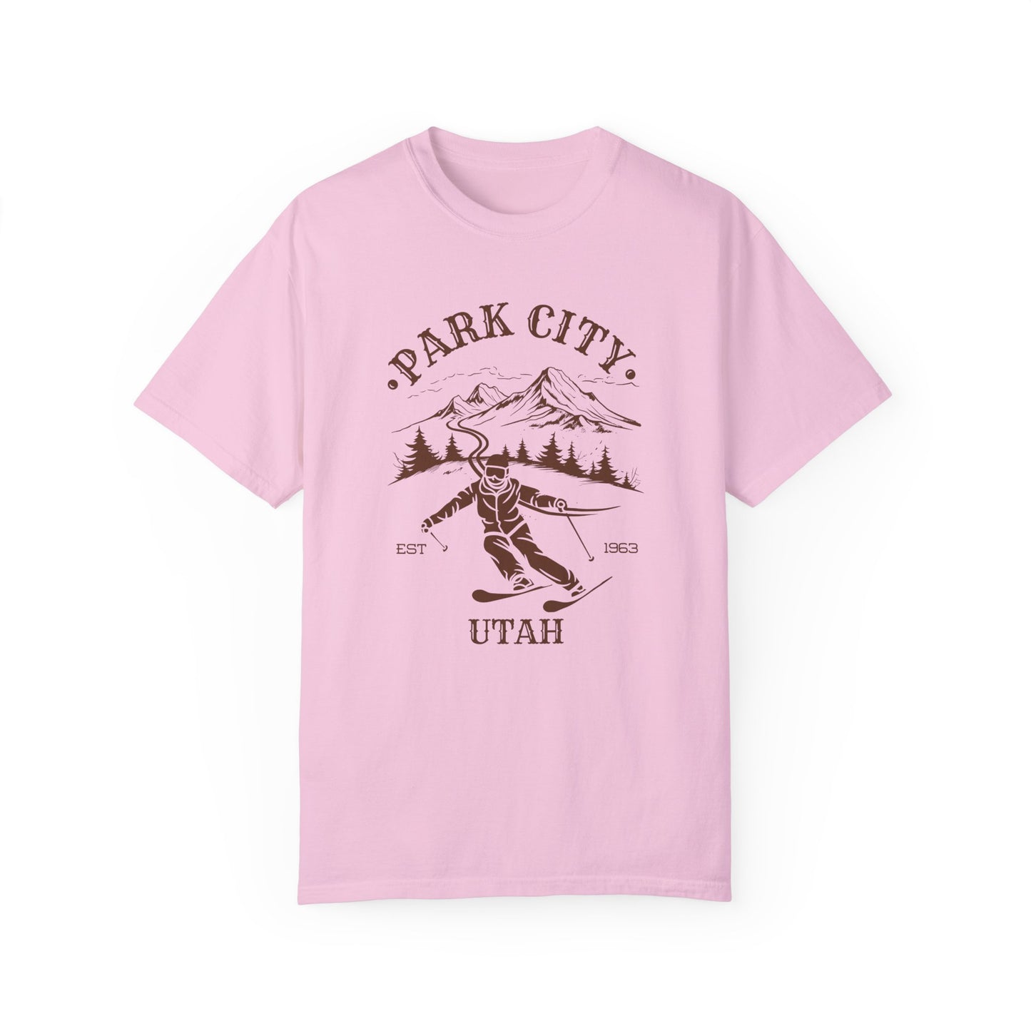 A pink t-shirt featuring a skier silhouette with a ski mountain backdrop and the text 'PARK CITY UTAH'.