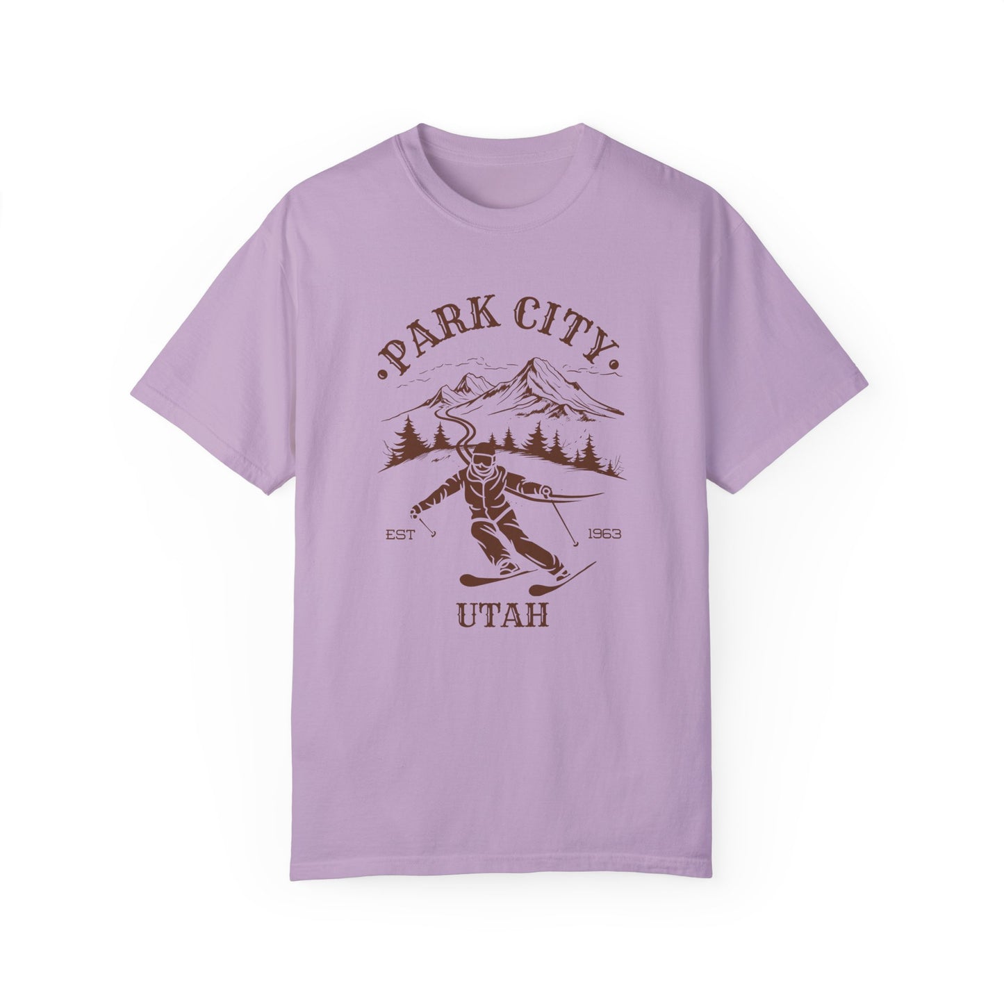 A purple t-shirt featuring a skier silhouette with a ski mountain backdrop and the text 'PARK CITY UTAH'.